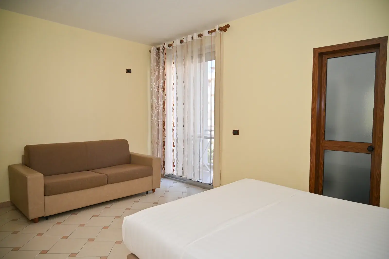 Sofa bed beside the balcony door — Vila Emes, Plazh, Durrës